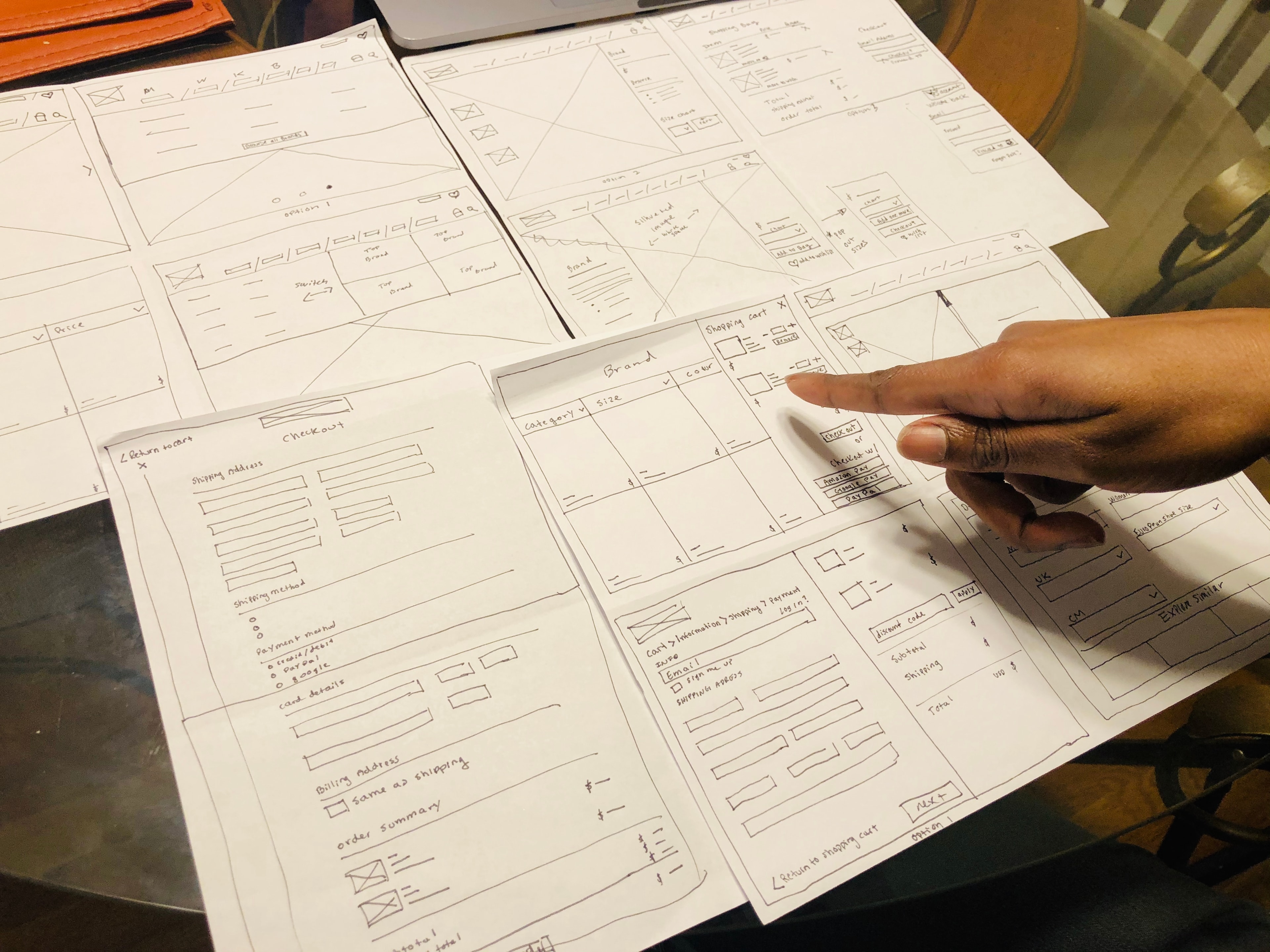 Paper prototypes of Expressions shopping and checkout screens laid out for testing